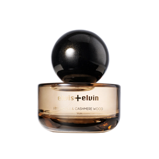 Patchouli and Cashmere Wood perfume bottle with black dome cap and amber glass