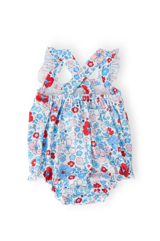 Blue floral ruffle cross-back romper with red details and shoulder ruffles
