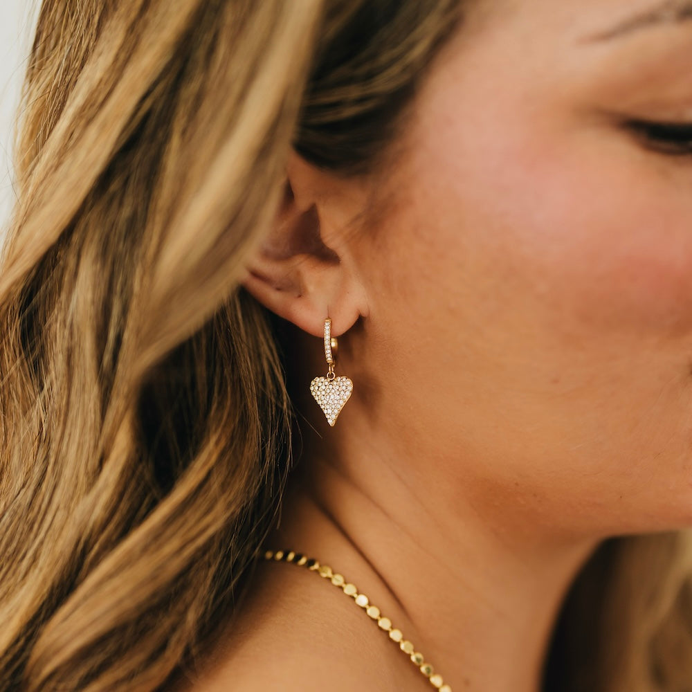 Gold huggie hoop earring with pavé heart charm