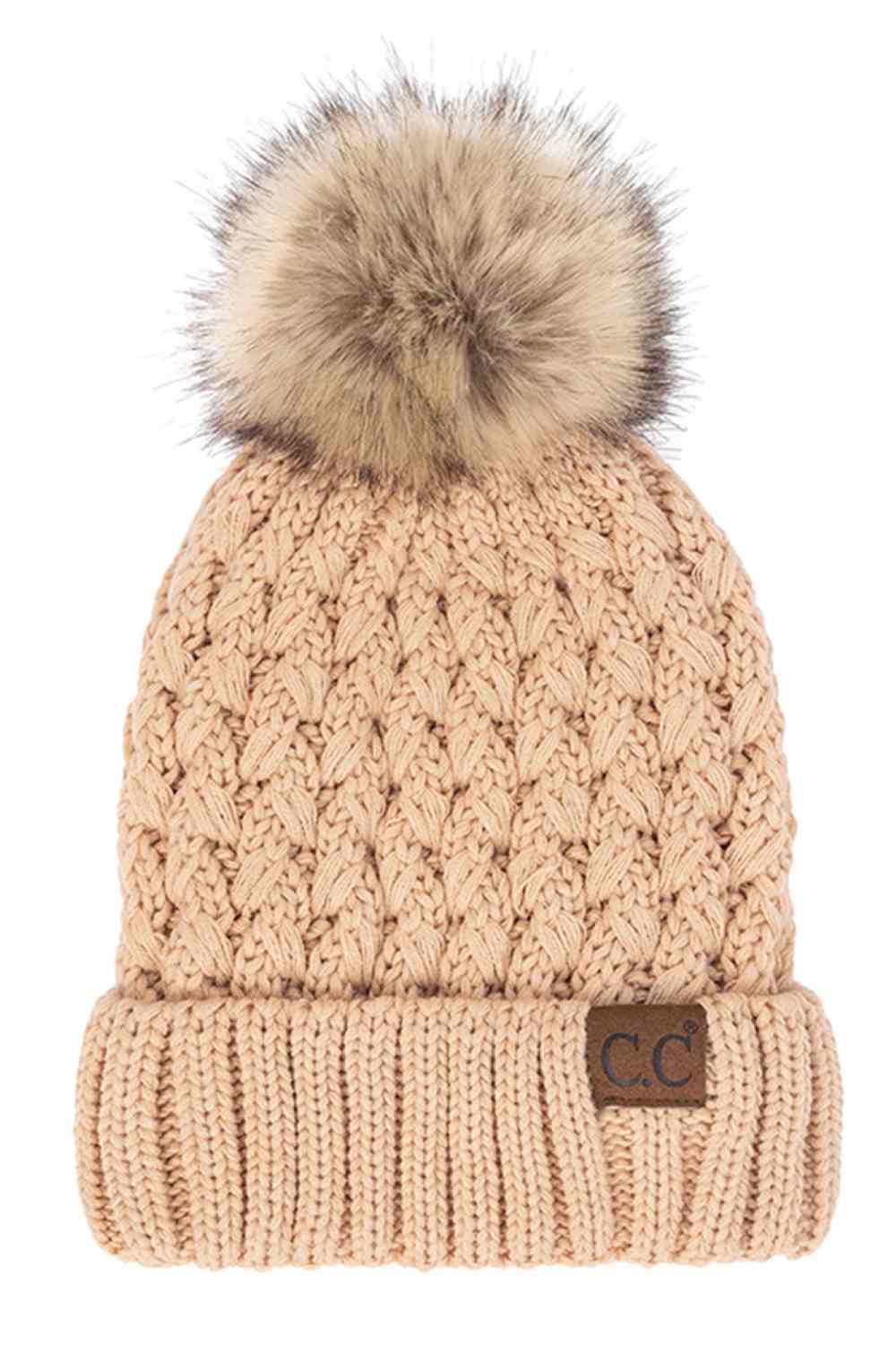 Blush beige knitted beanie with fluffy pom-pom and C.C patch on ribbed cuff.