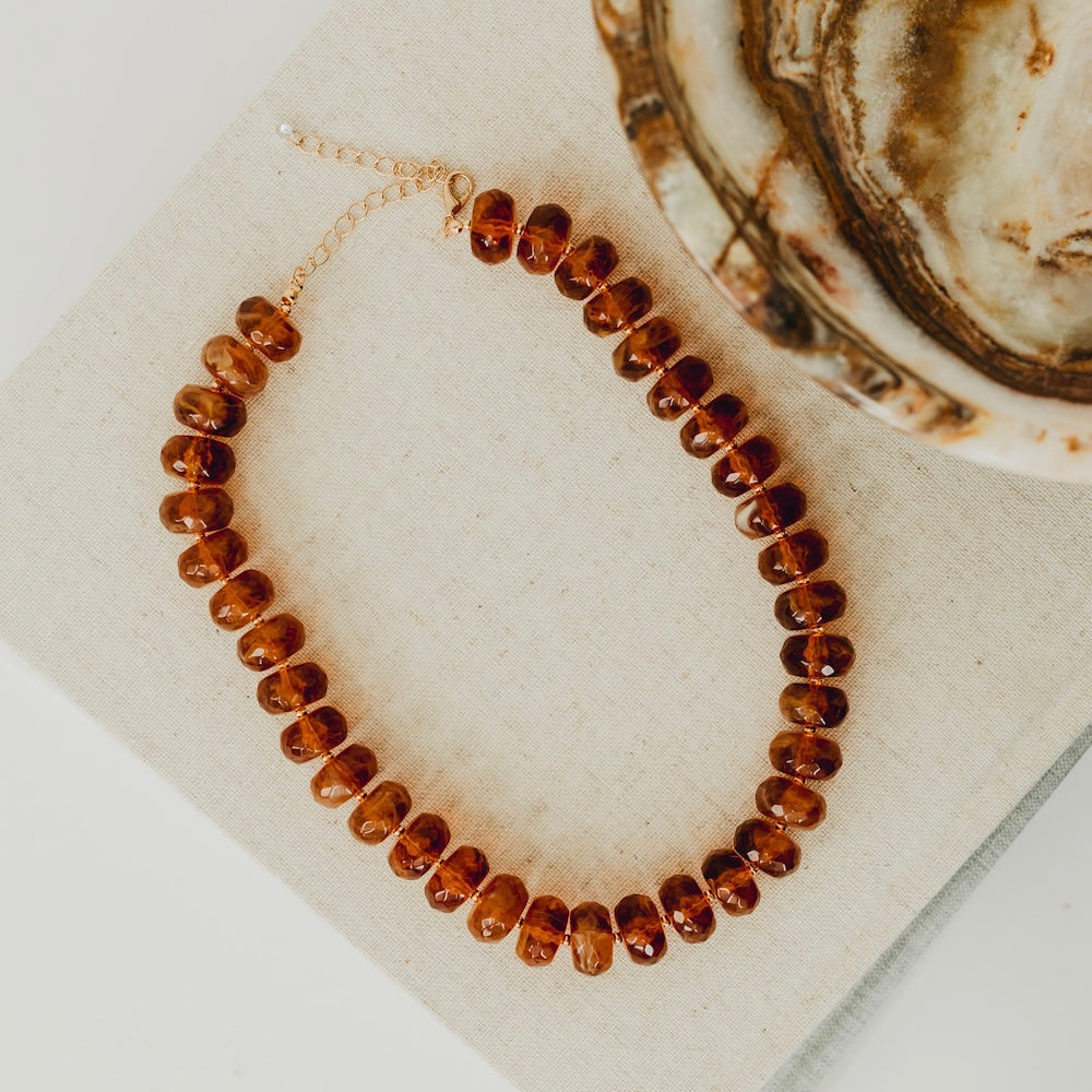Dark amber resin beaded necklace with round faceted beads and gold chain