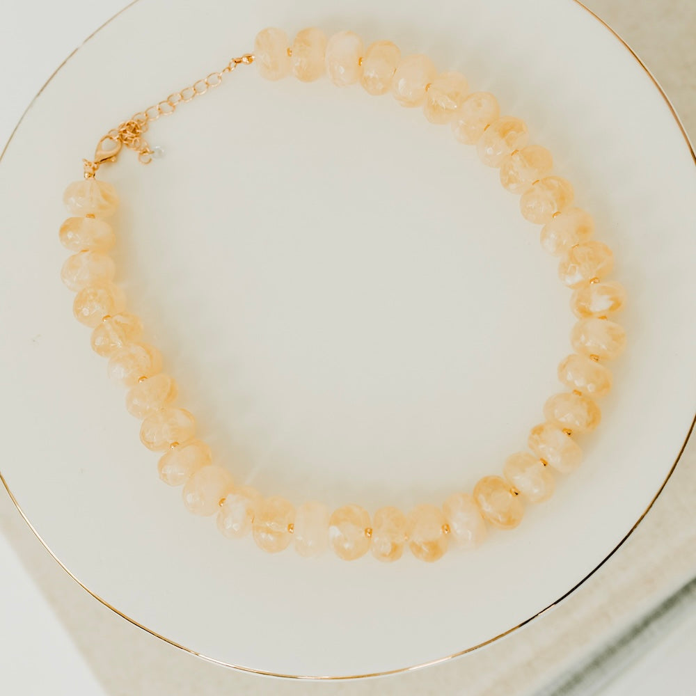 Ivory resin beaded necklace with round faceted beads and gold chain