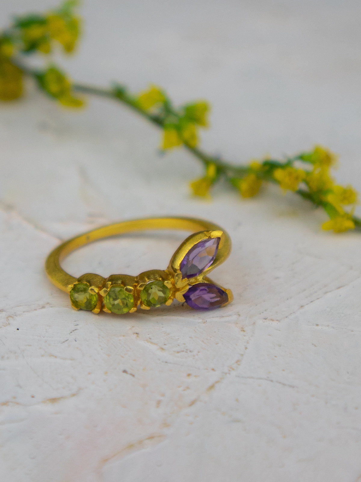 Gold peridot-and-amethyst vine ring with purple amethyst marquise top and green stones
