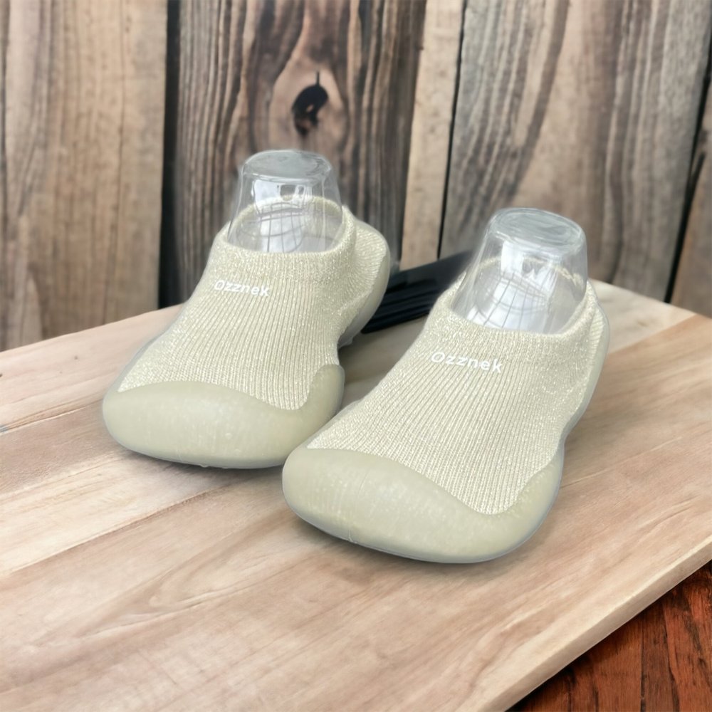 Ivory baby sock shoes with clear soles, knit upper and rounded toe