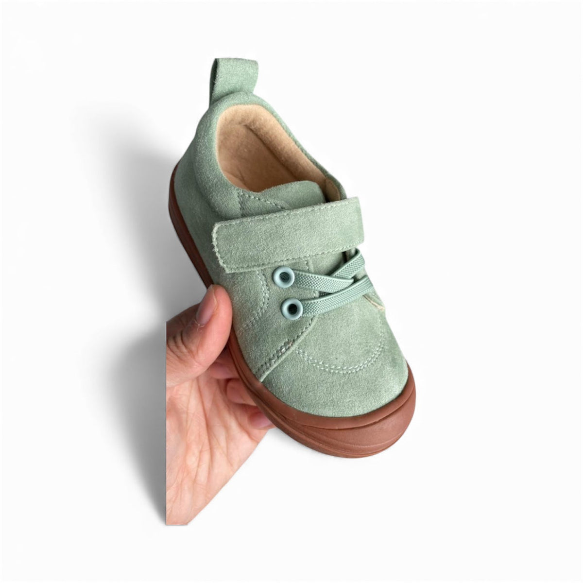Kids mint green suede-style barefoot sneaker with hook-and-loop strap and rubber sole.