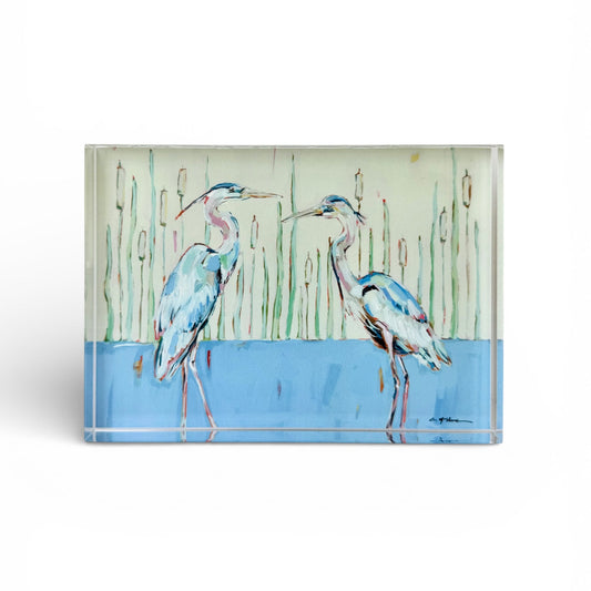 Tabletop acrylic art panel with two blue herons, reeds, and blue water scene