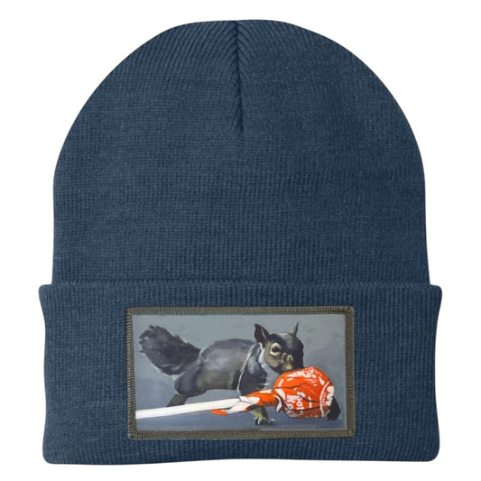 Dusty blue knit beanie with embroidered squirrel patch on the cuff