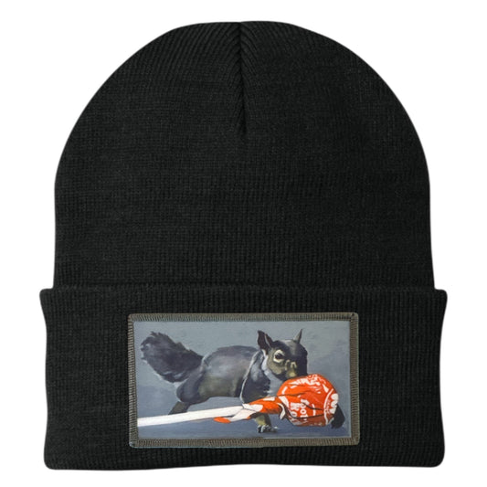 Black knit beanie with embroidered squirrel patch on the cuff
