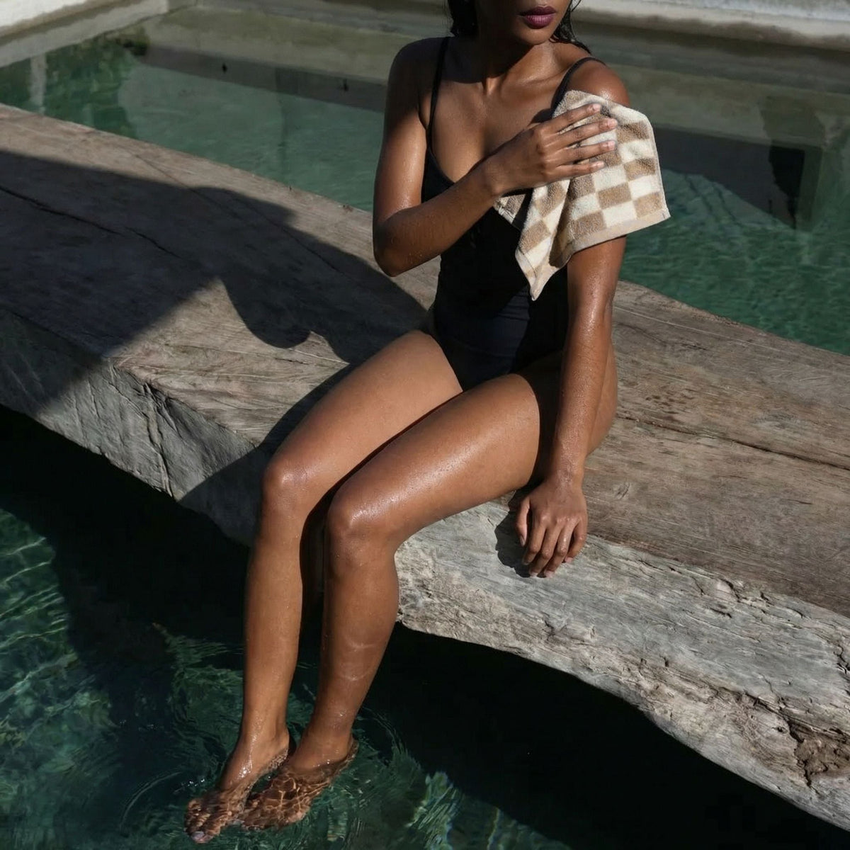 Checkered cotton towel draped by a person, tan and ecru