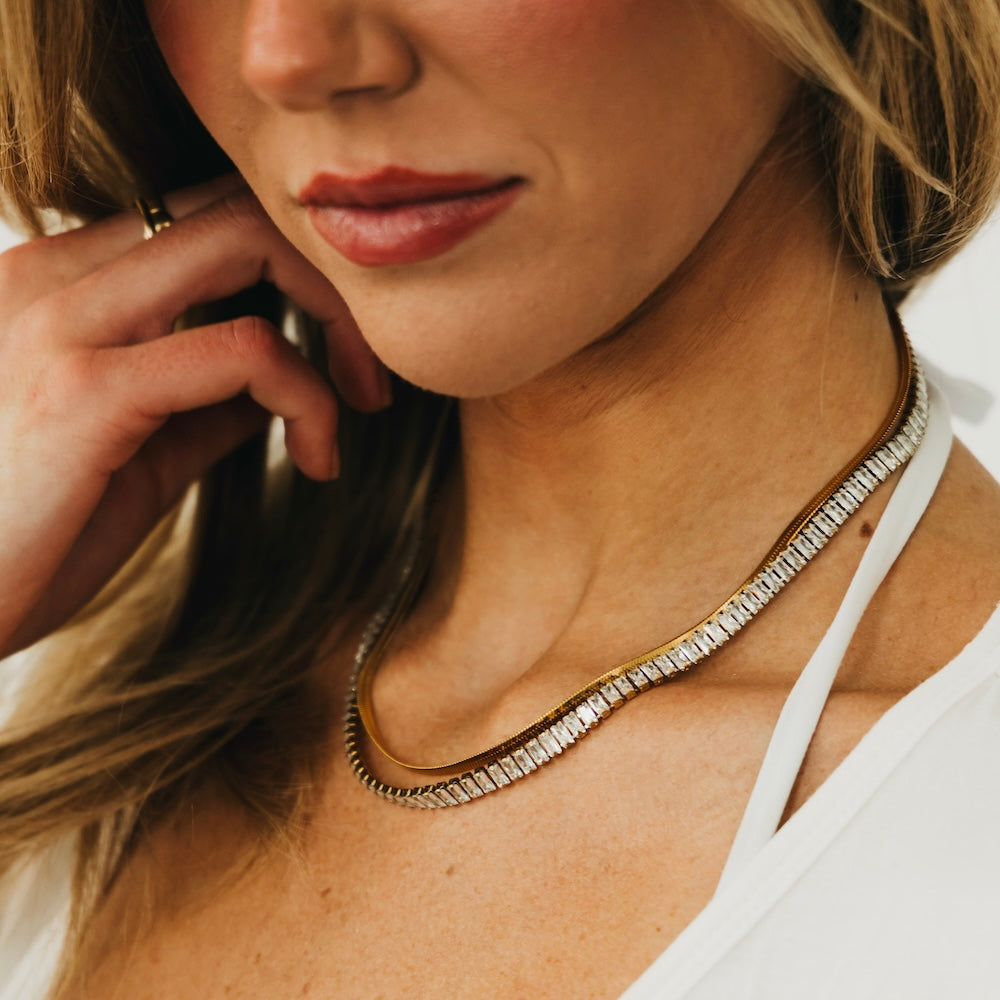 Gold layered necklace with textured pave edge along the collar