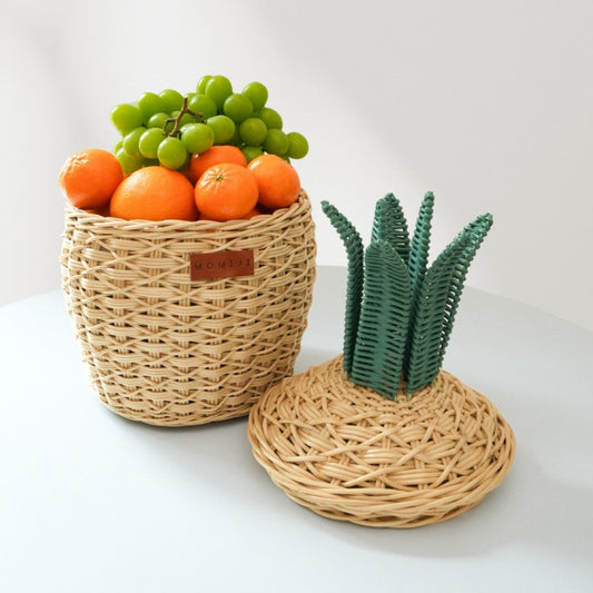 Natural rattan pineapple storage basket shown open with a separate leafy lid