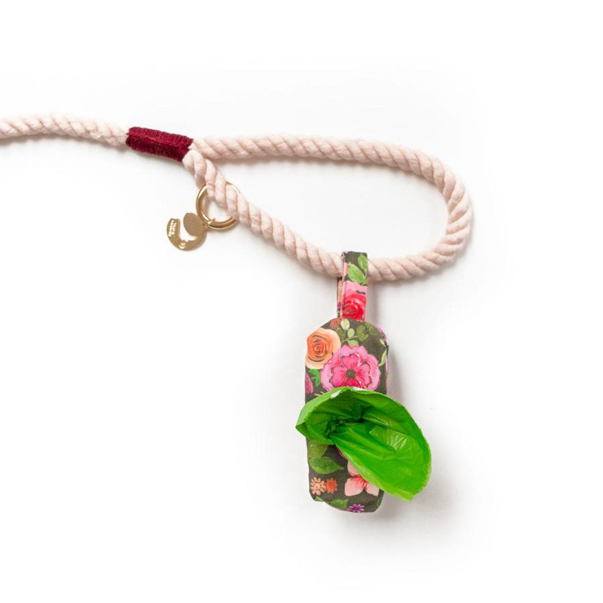 Pink braided rope dog leash with burgundy tassel and floral charm, brass hook