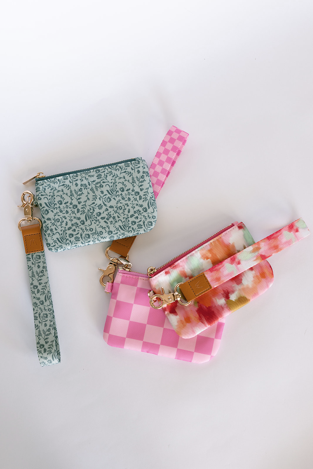 Set of two small zip pouches: teal floral and pink checkered, gold hardware