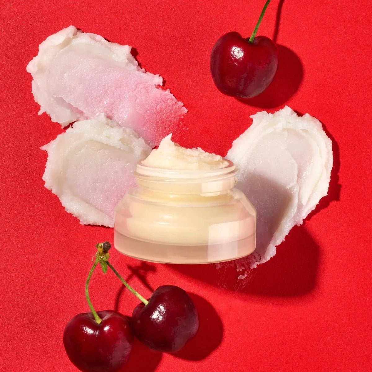 Lip mask jar with pink and white cream swirls and red cherries