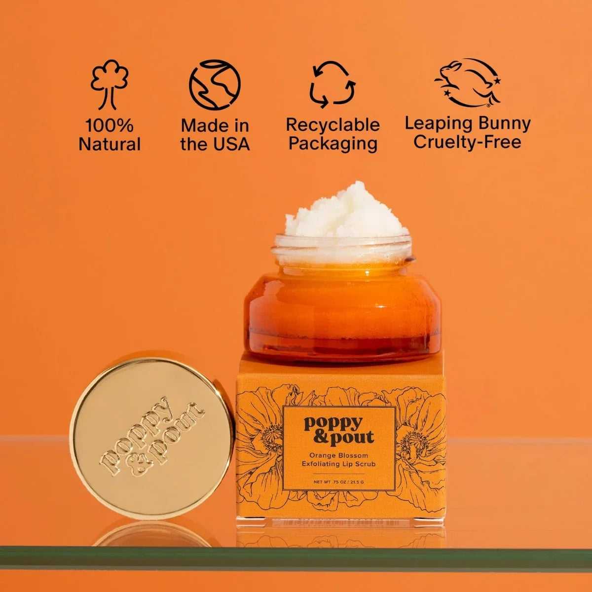 Orange blossom lip scrub jar with matching round lid, amber base, white scrub
