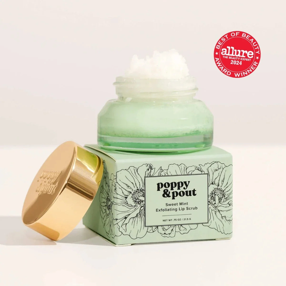 Sweet Mint lip scrub jar with gold lid beside floral-printed box
