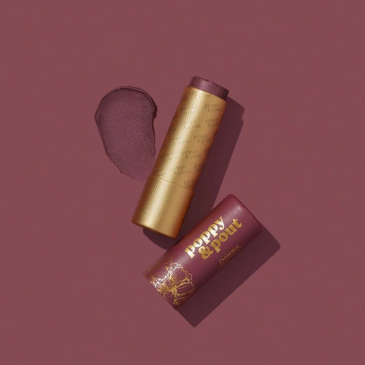 Lip tint duo: metallic gold tube with dark mauve swatch