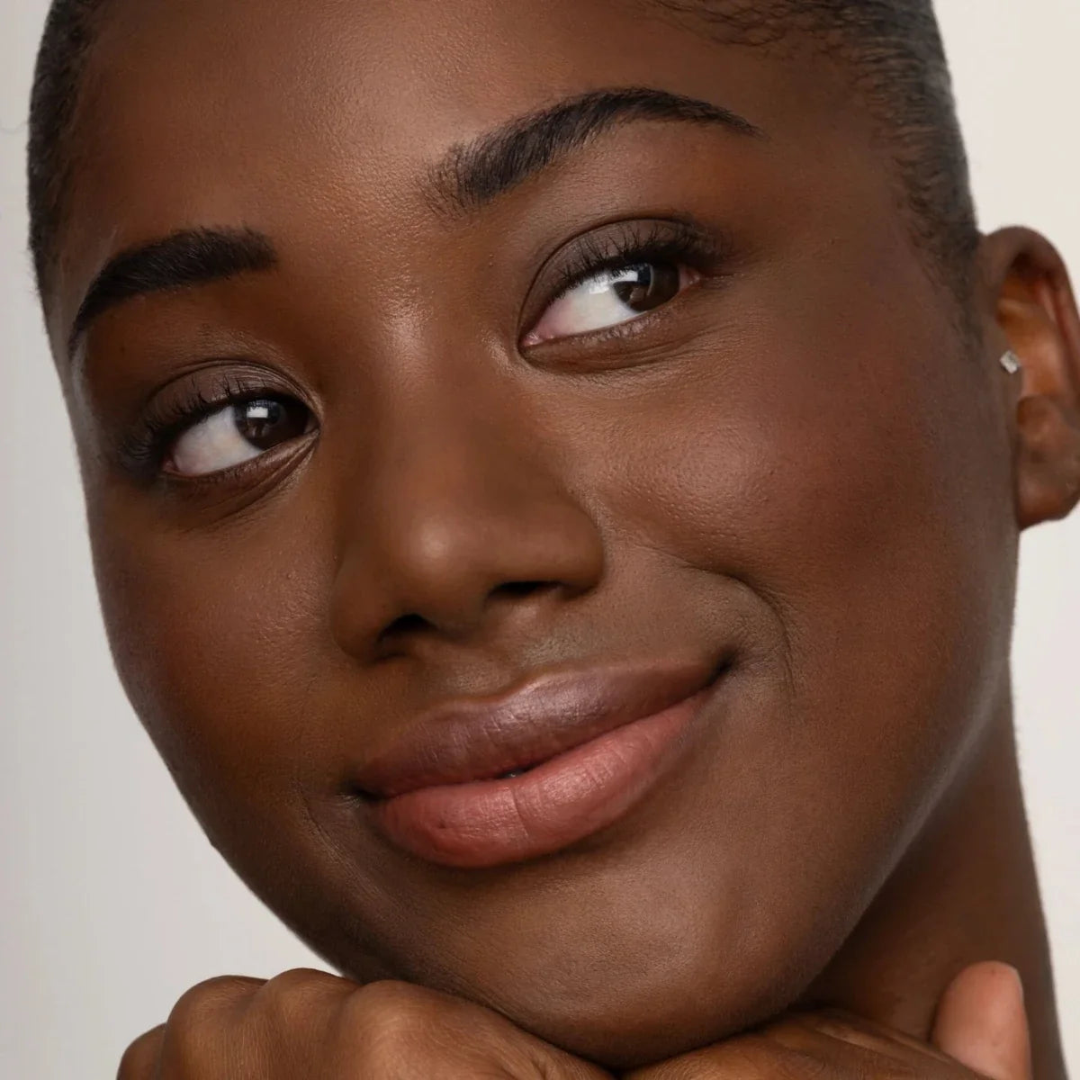 Lip tint wear on full lips, rose-brown glossy finish