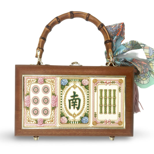 Brown box bag with bamboo handles, colorful mahjong panel front, and hanging tassel