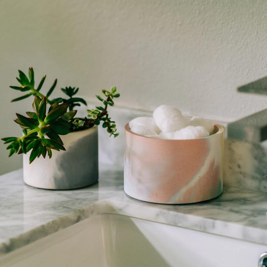 Ceramic round planter with pale cream and pink two-tone glaze, holding white cotton balls.