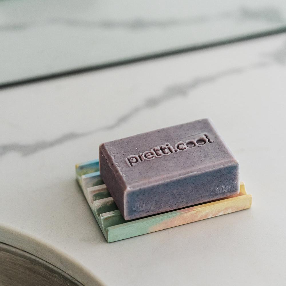 Rectangular soap tray holding a lavender soap bar