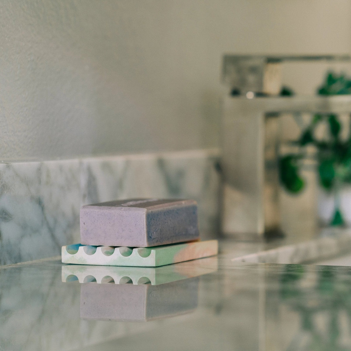 Clear rectangular soap dish with pastel base and soap bar