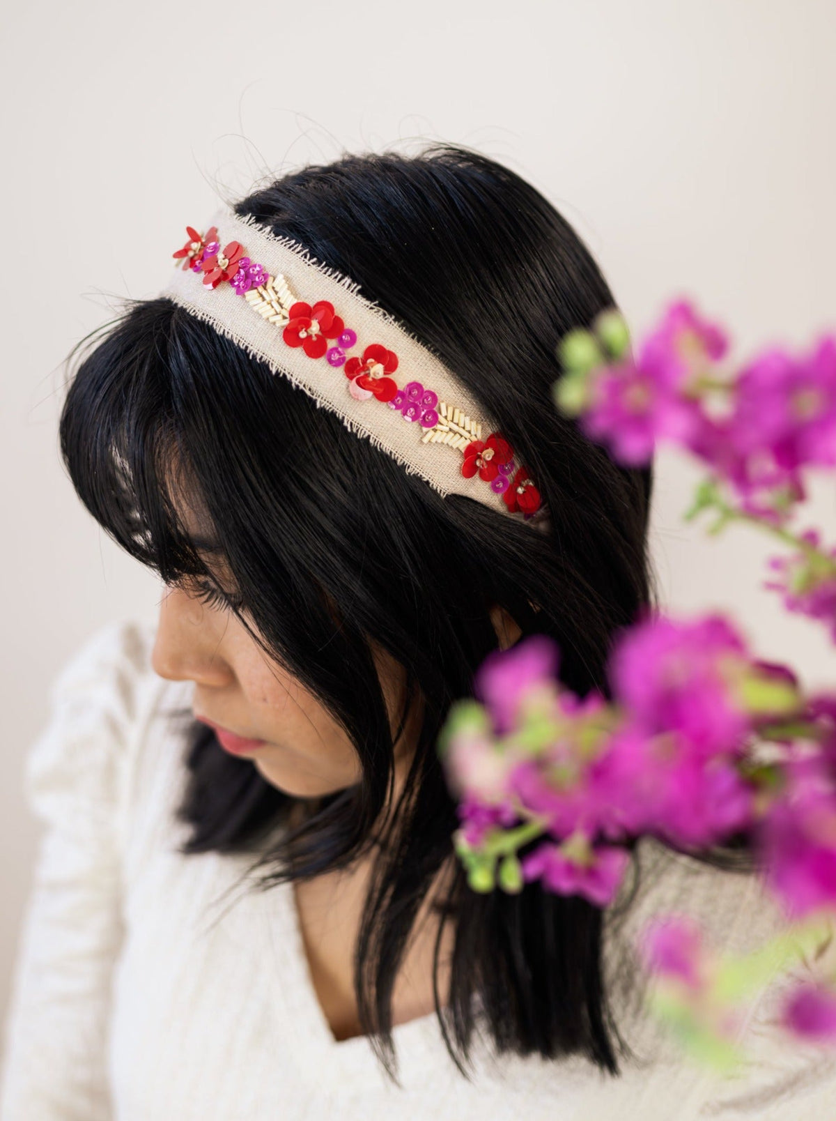 Cream beaded headband with red flower beads and purple accents