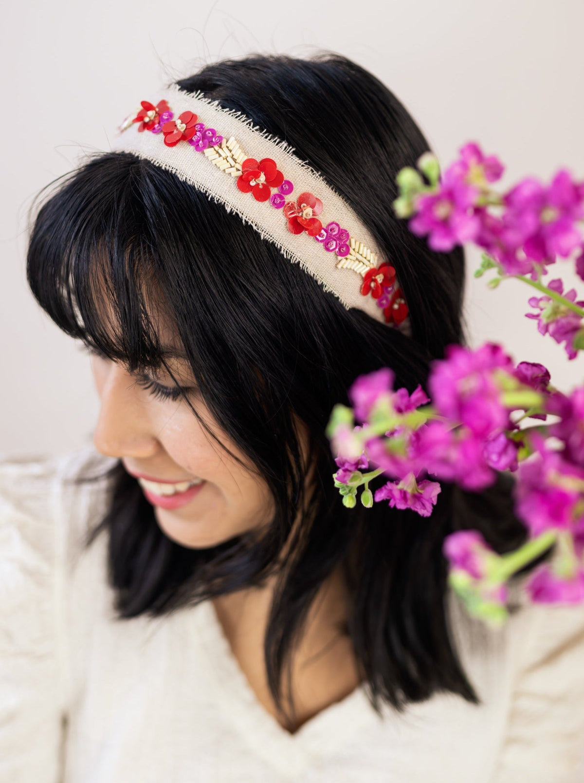Cream beaded headband with red and purple floral bead accents