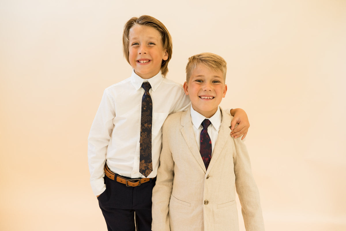 Boys patterned neckties in navy and merlot, worn with dress shirts