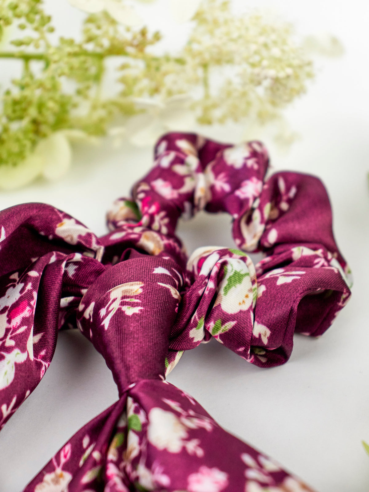 Purple satin floral scrunchie with ruched bow detail