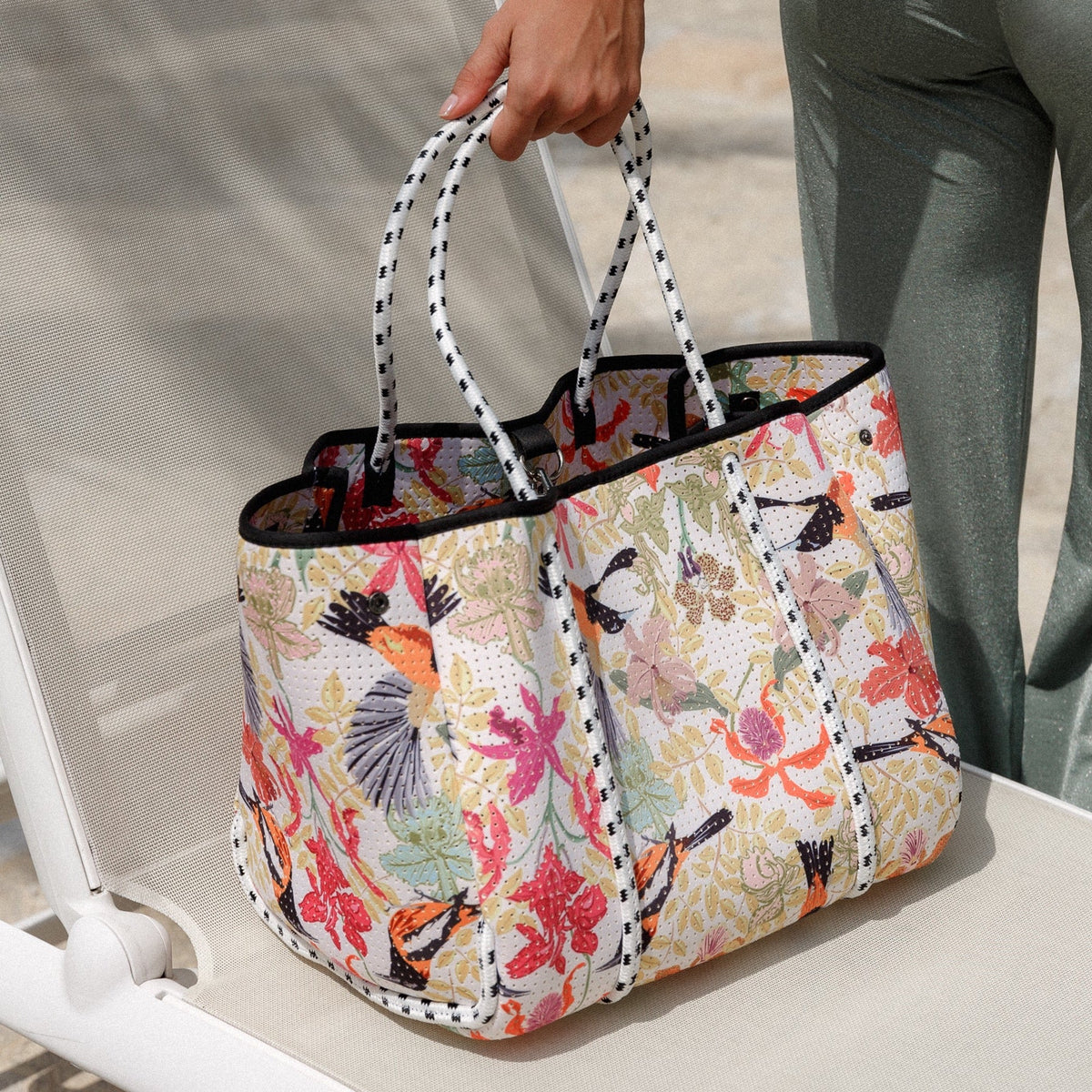 Floral canvas tote bag with striped handles and front pocket
