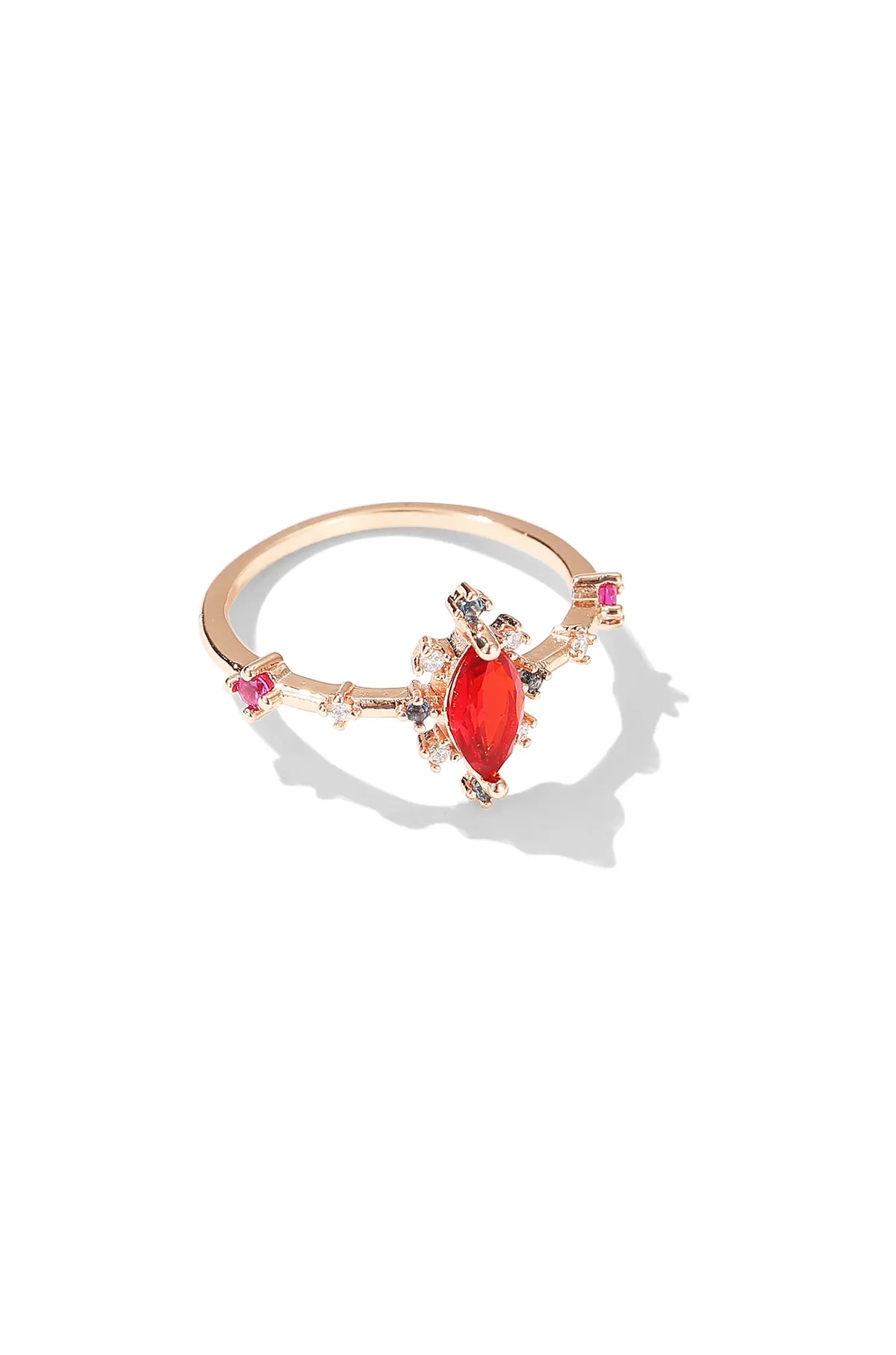 Rose gold ring with a red marquise-cut center stone and small colored accents
