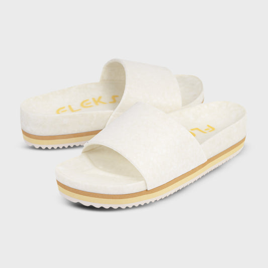Cream suede-like slide platform sandals with wide strap and tan rubber sole