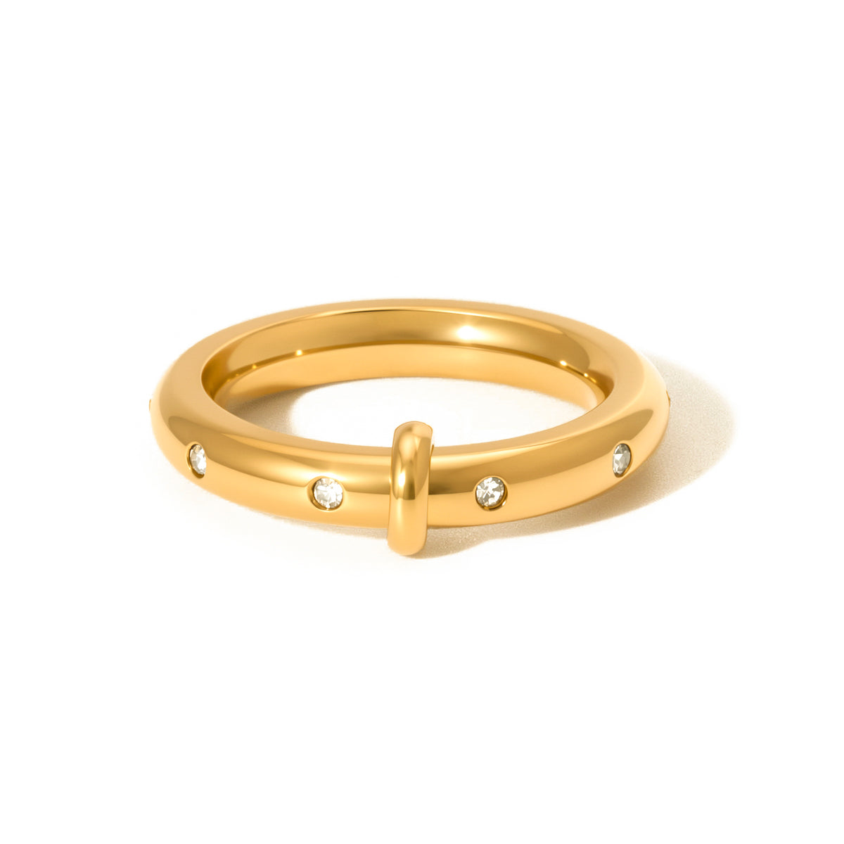 Gold tone diamond-studded ring with center detail and round stones