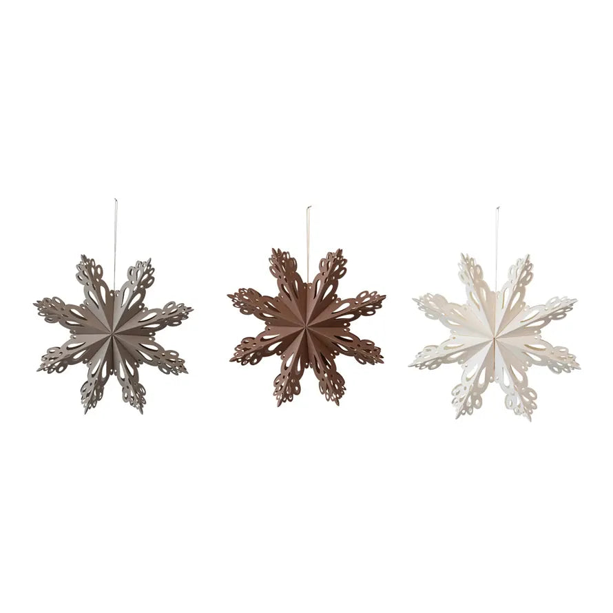 Hanging paper snowflake ornaments in silver gray, dark brown, and white
