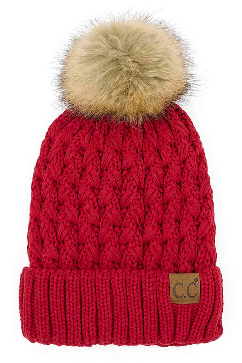 Red knitted beanie with fluffy pom-pom and C.C patch on ribbed cuff.