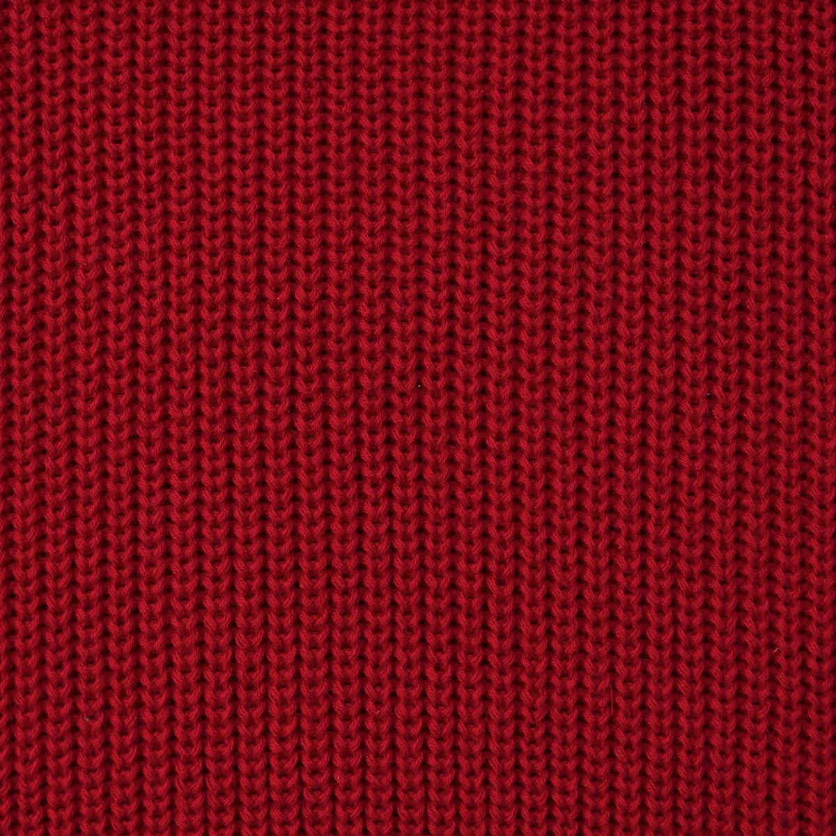 Red knit fabric close-up with textured stitch pattern.