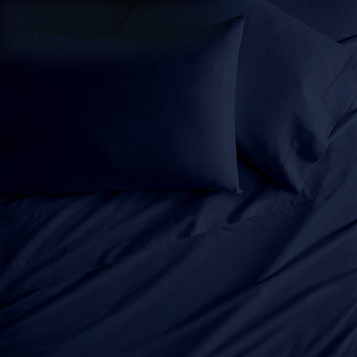 Organic flannel sheet set, navy fabric with wrinkles and folds