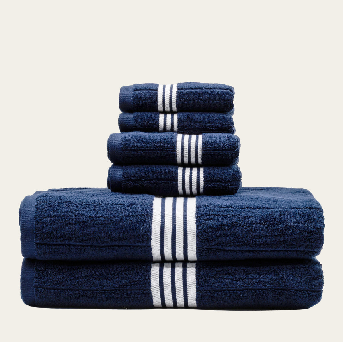Navy cotton bath towels with white striped bands, folded stack of two towels.