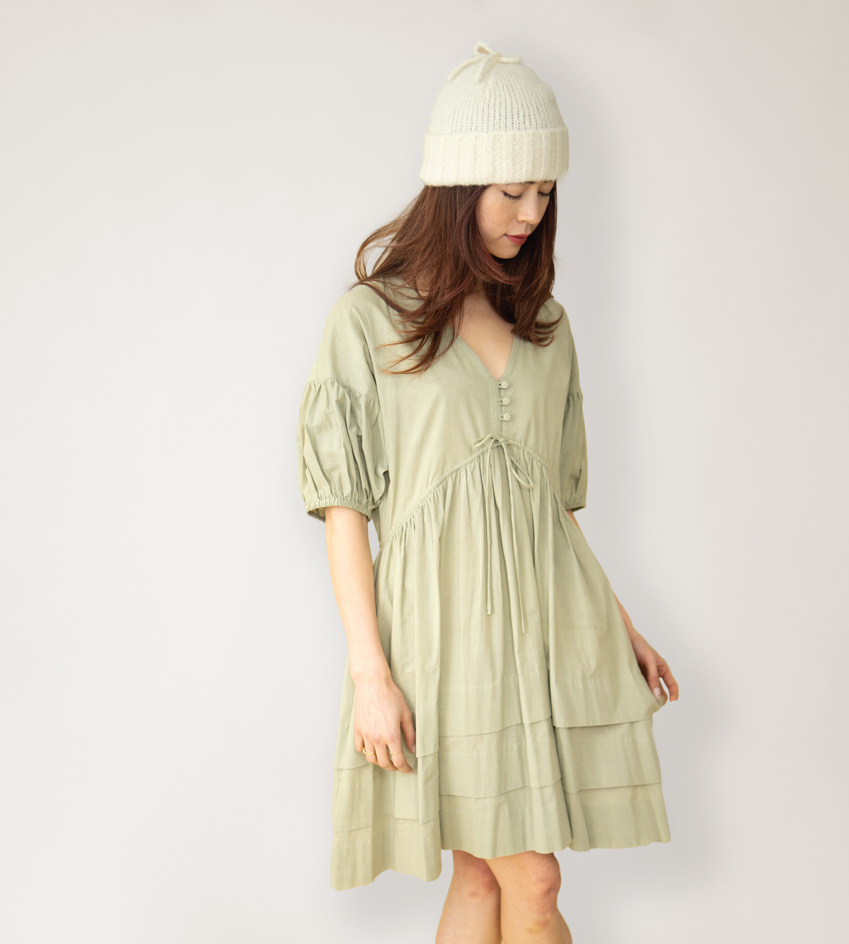 Poet Dress in pale sage with a V-neck, puff sleeves, gathered waist, and tiered hem