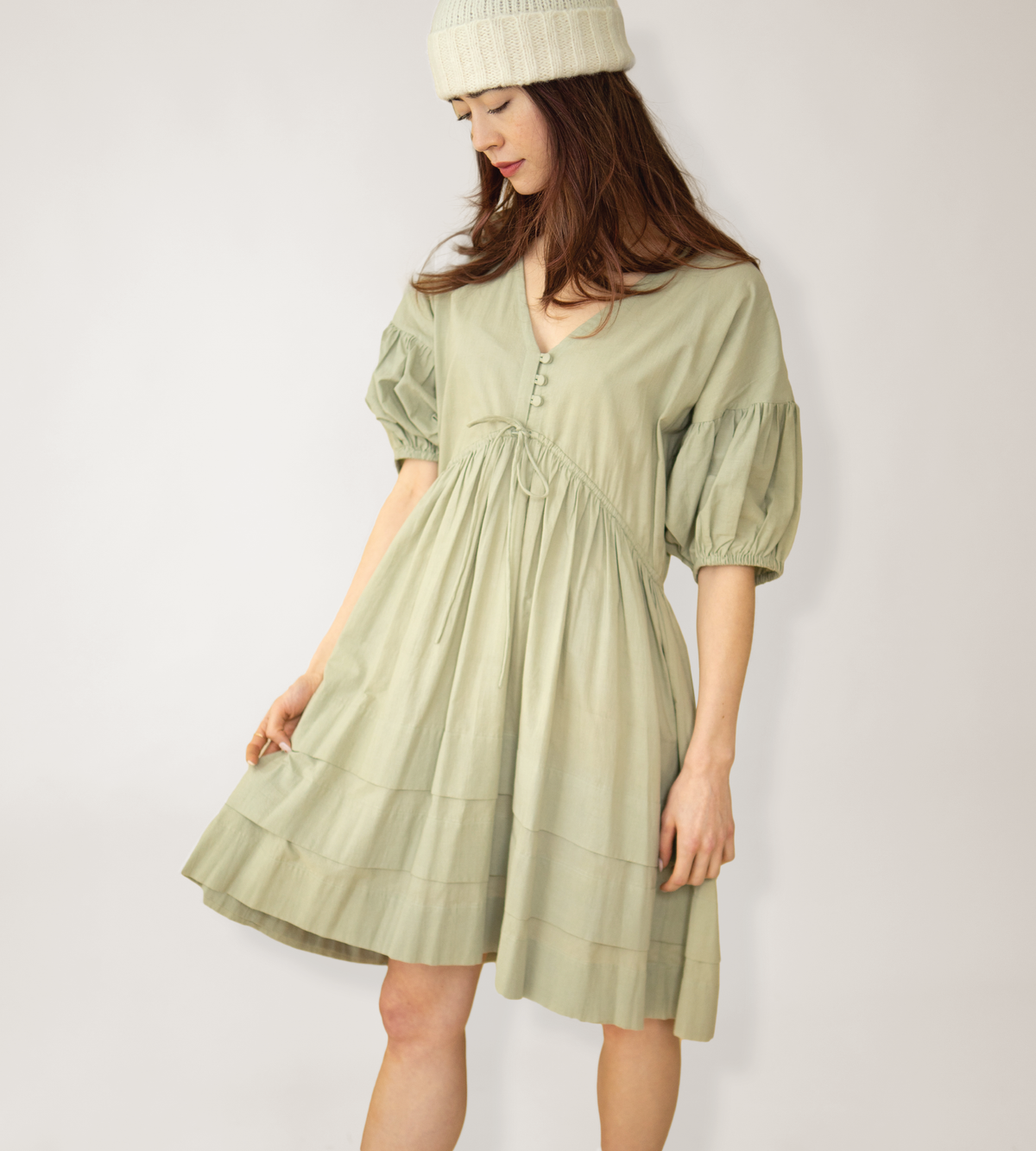 Poet Dress shown with a flared tiered skirt and gathered three-quarter sleeves