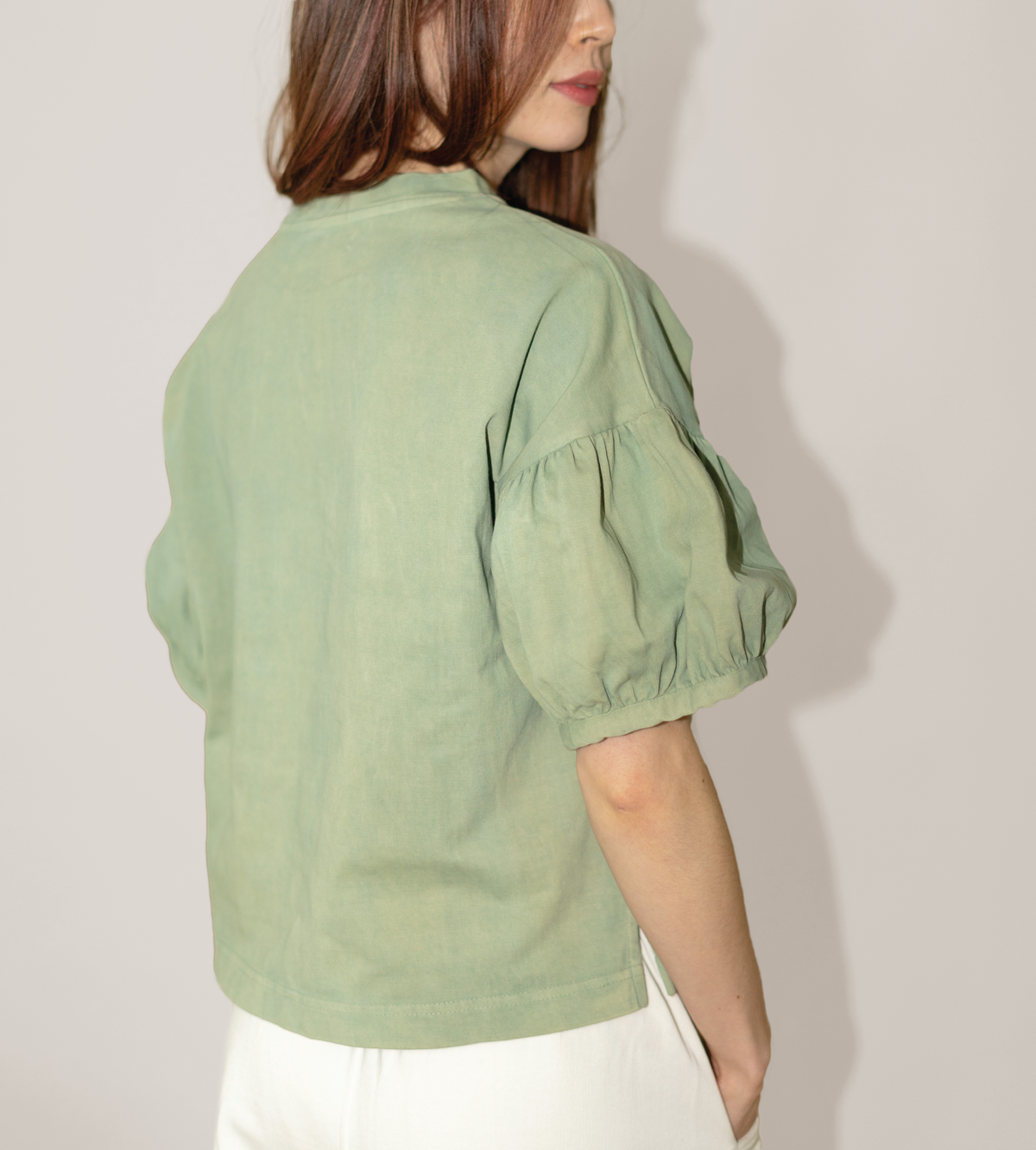 Side and back view of a sage green tee with gathered puff sleeves