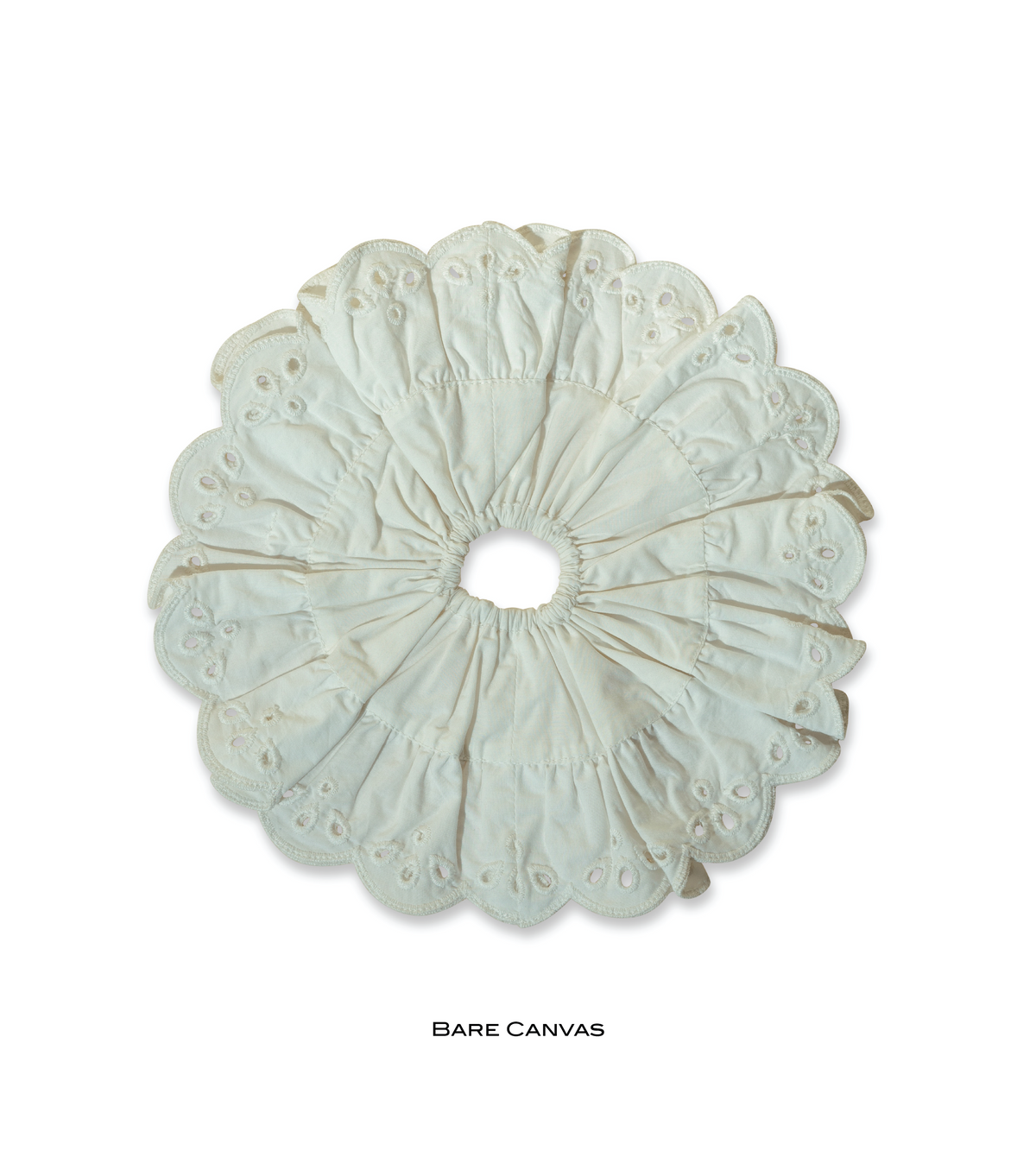 Bare Canvas eyelet scrunchie in a pale neutral shade with gathered fabric and scalloped edges.