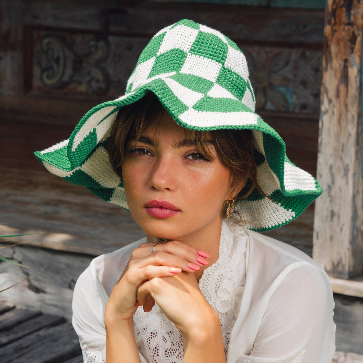 Green and white checkered crochet hat with wide floppy brim