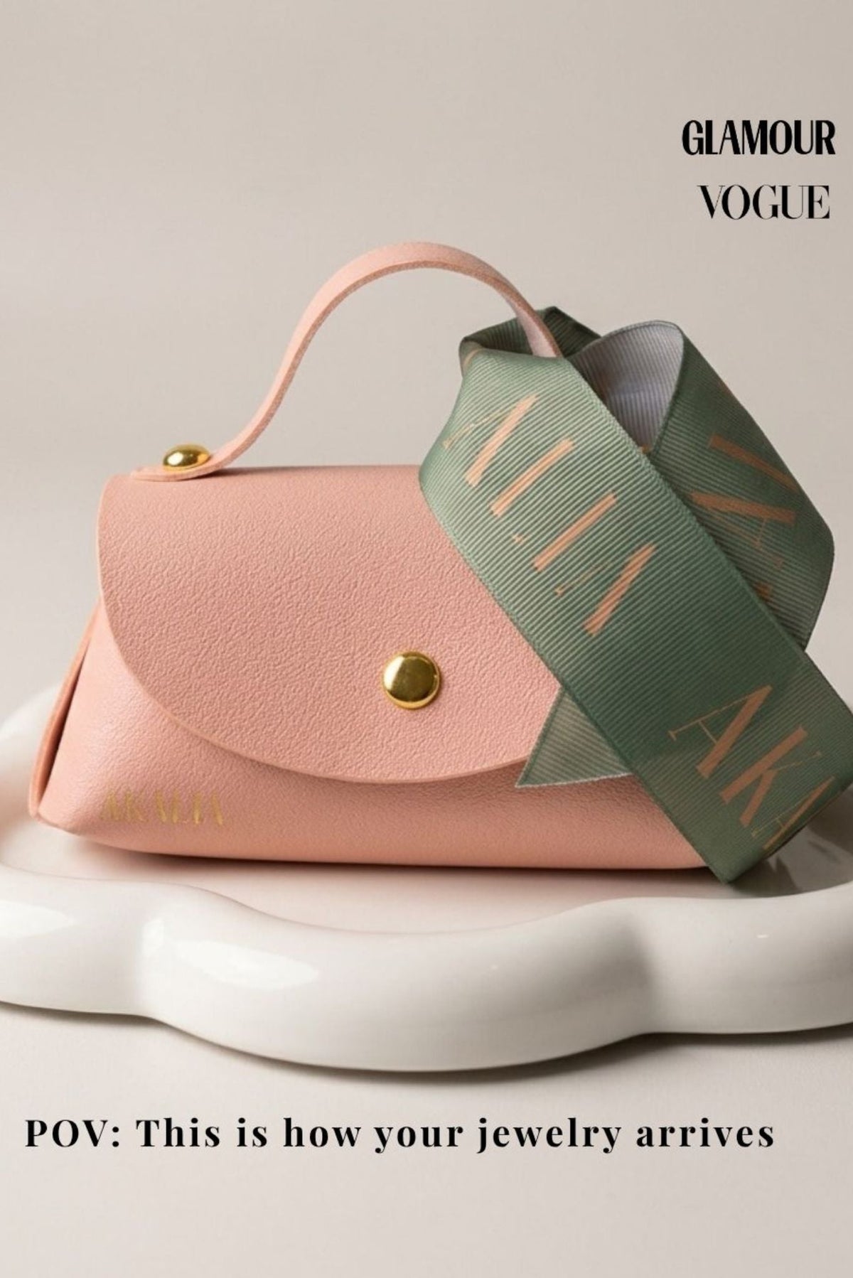 Gold crystal link bracelet in rose pink pouch with green patterned ribbon