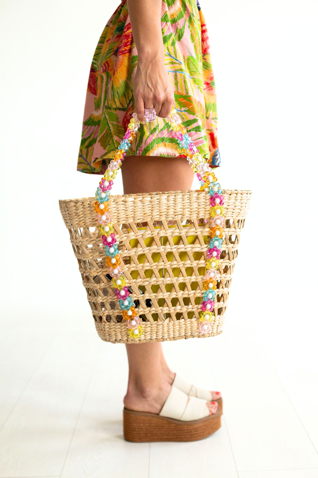 Woven straw beach tote bag with multicolor beaded trim and top handles
