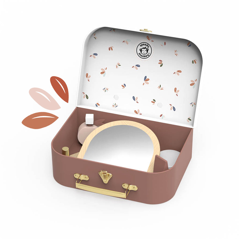 Mini makeup vanity suitcase, open with mirror and assorted beauty tools on tabletop
