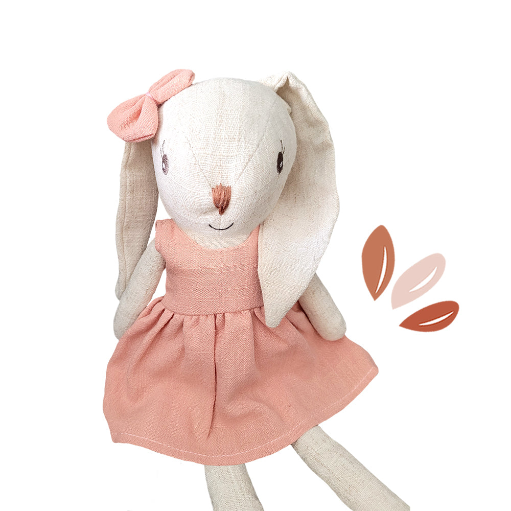 Plush bunny doll in pink dress with bow, soft ears, and friendly face