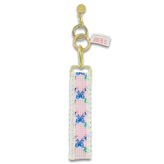 Blue lace bow keyfob with gold clasp, ribbon bow print, and hanging tag.