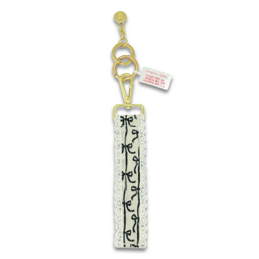 Black lace keyfob with floral motif, gold chain and clasp